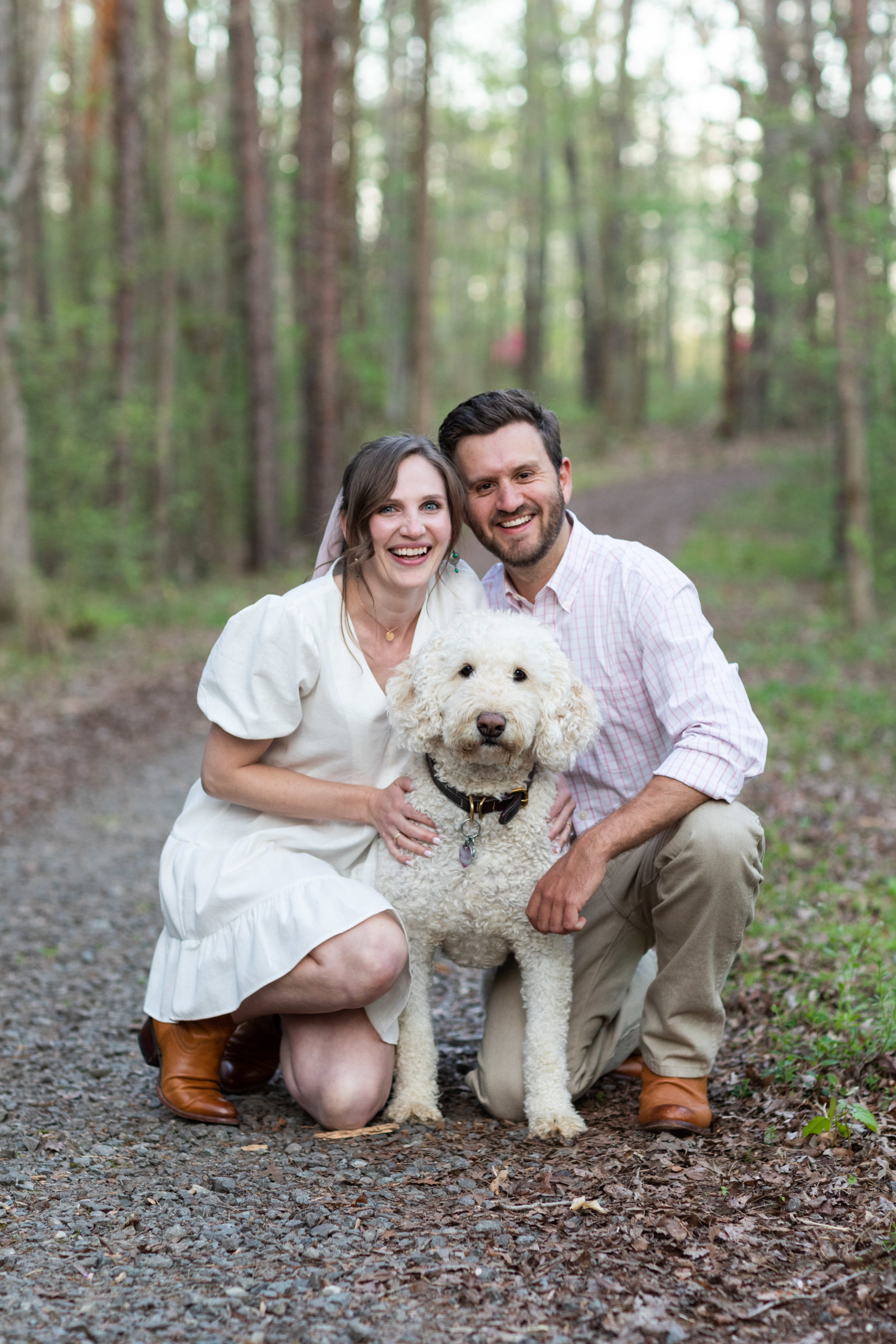 couple posing with poodle dog