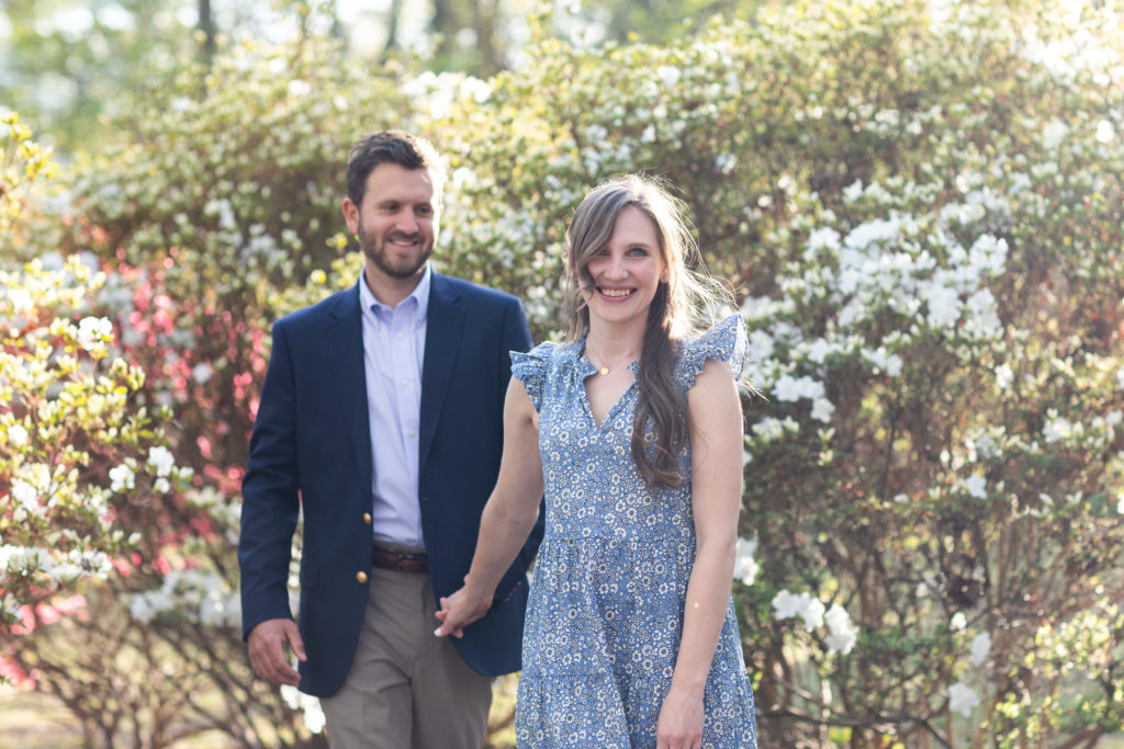 couple walking together in a garden
